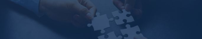 Background image of a hand holding puzzle pieces